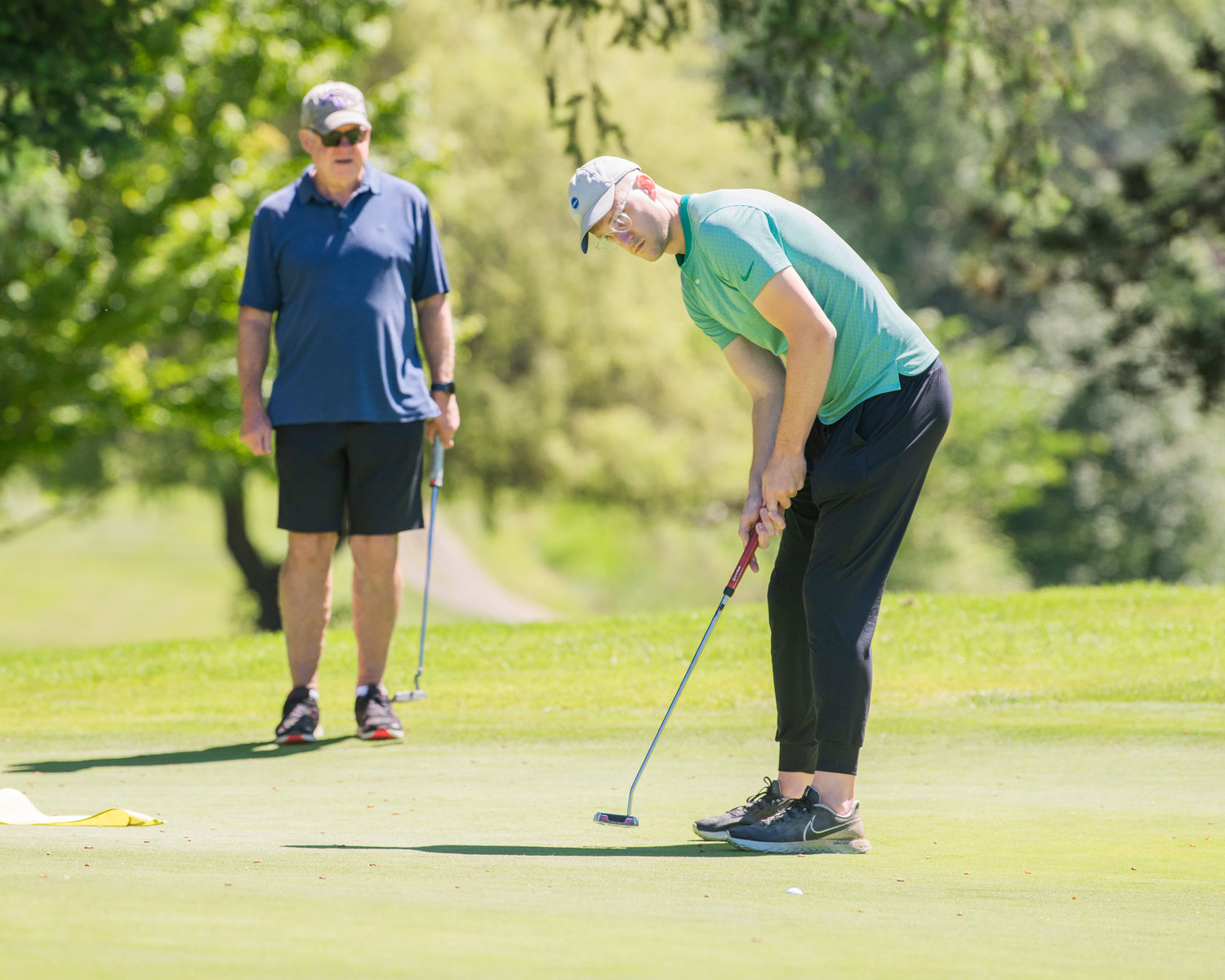 Mark McHugh makes a birdie during a charity golf tournament at Riverside Golf Course in Chehalis on Friday.